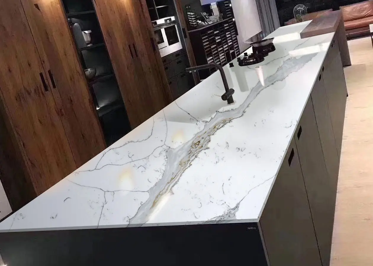 Long kitchen island in Calacatta 6009 quartz against dark wood cabinets